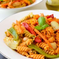 This vegetarian Sicilian pasta recipe is easy to make and full of the flavours of the Mediterranean. Sweet bell pepper, crisp carrots, artichoke hearts and white beans in a simple tomato sauce make a hearty and satisfying 15-minute meal.