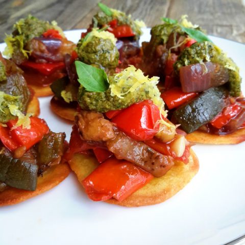Fresh, sweet ratatouille served on mini socca bites and topped with vegan pesto. Delicious finger food for your next party!