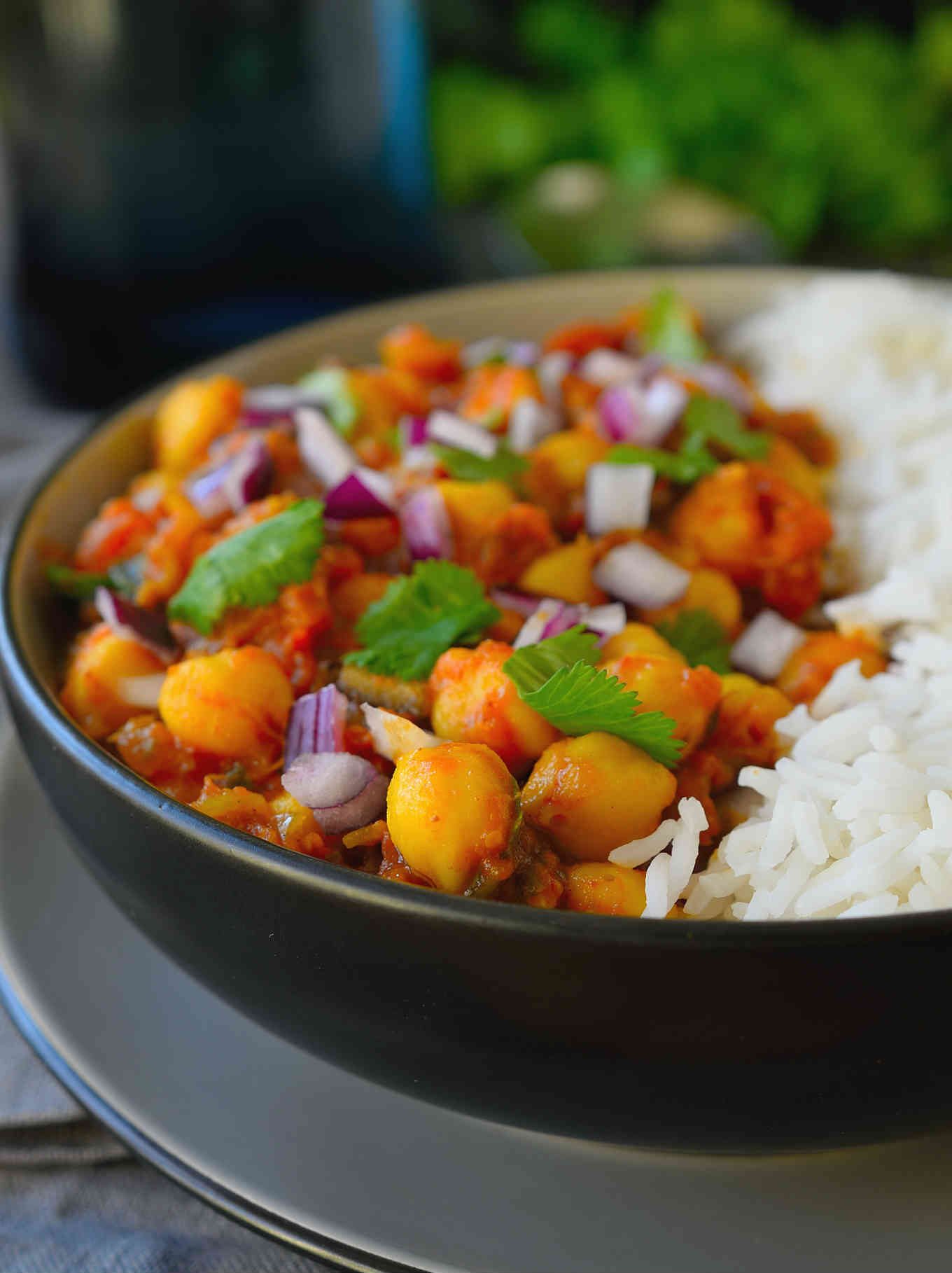 Vegan chickpea curry is an easy and flavourful tomato-based curry great for a weeknight dinner. Adjust the spice level to your preference with this recipe and feel free to add in other greens and veggies like kale, spinach or broccoli for a healthy and satisfying meal! 
