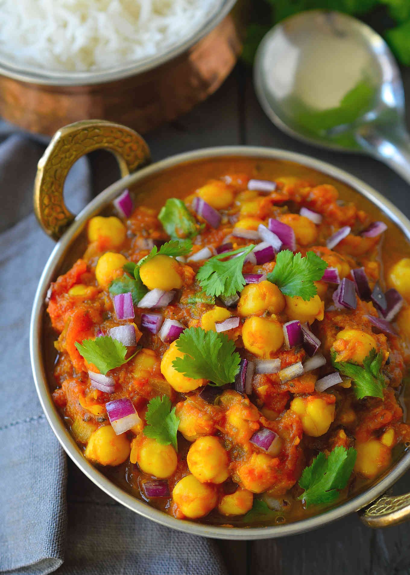 Vegan chickpea curry is an easy and flavourful tomato-based curry great for a weeknight dinner. Adjust the spice level to your preference with this recipe and feel free to add in other greens and veggies like kale, spinach or broccoli for a healthy and satisfying meal! 