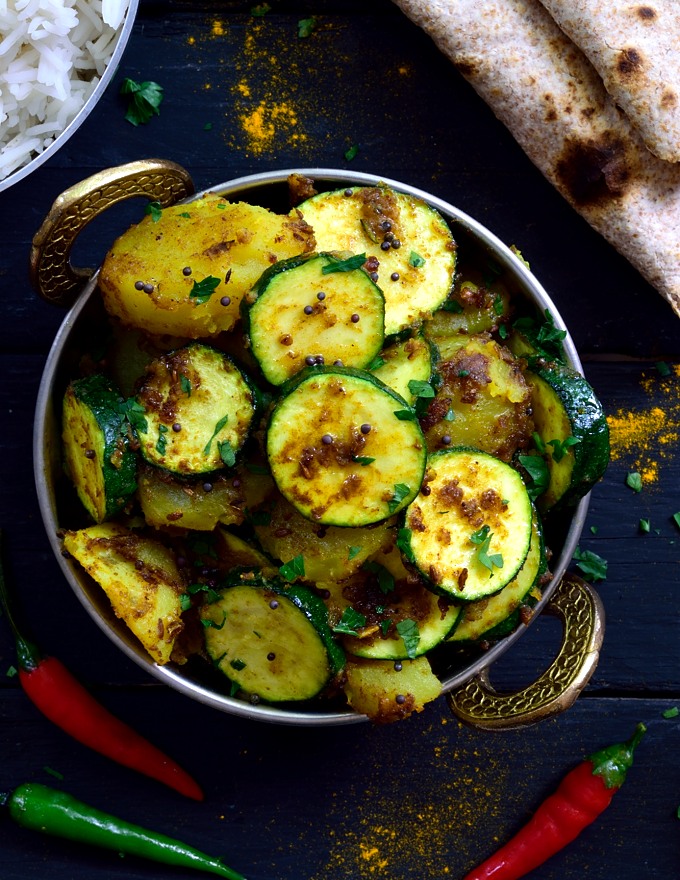 This simple dish of Indian-spiced potatoes and zucchini is a total flavour bomb! Two main ingredients and a handful of spices make up this tasty vegan or vegetarian dish. Can be served as a side or main along with rice and naan or chapati.