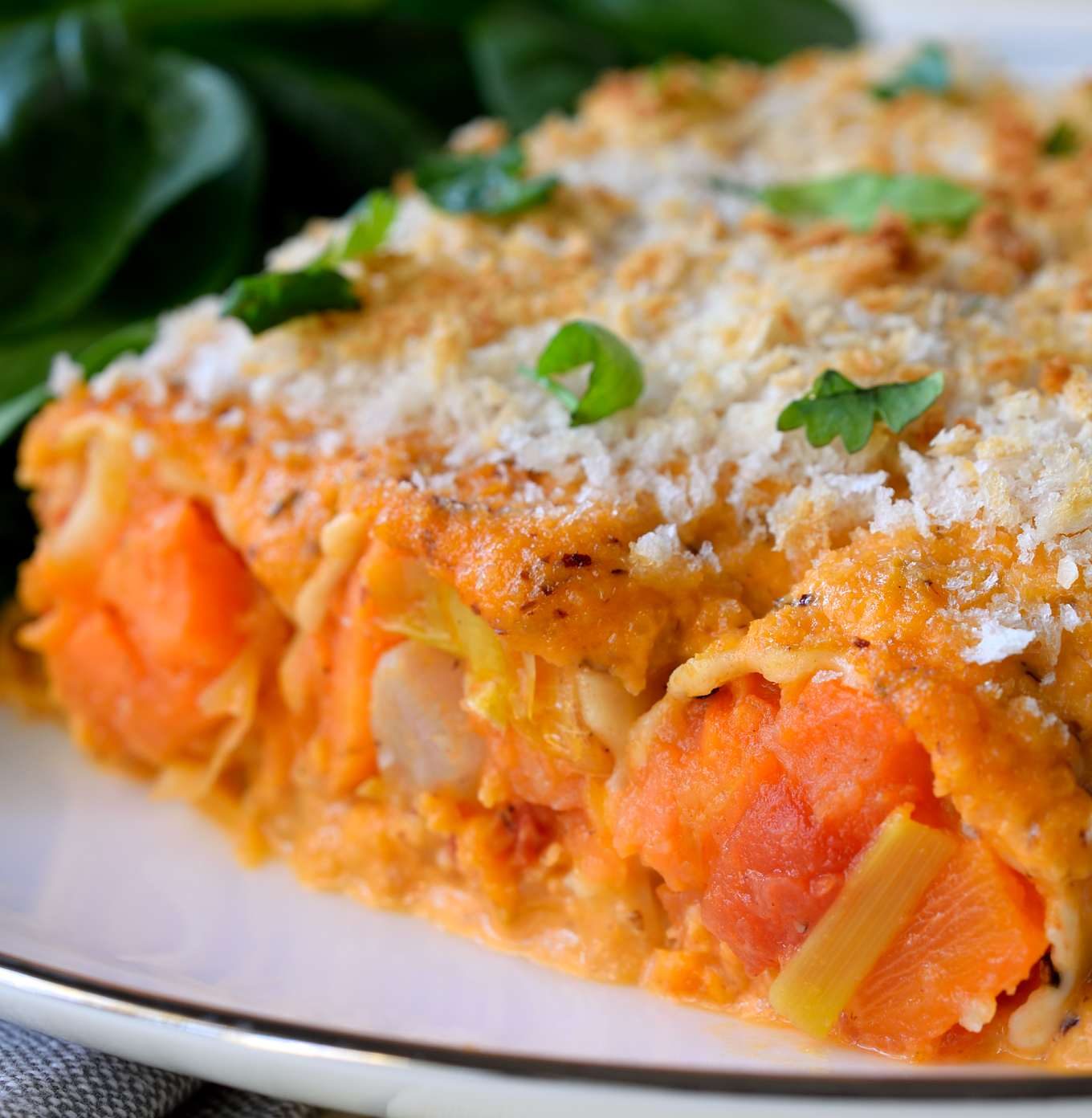 This vegan cannelloni recipe is a delicious soy-free dish to warm you up on a chilly evening. Roasted root vegetables are stuffed inside pasta tubes, smothered in a homemade romesco sauce and sprinkled with breadcrumbs for a crispy crust. This elegant dish uses the best of winter’s seasonal vegetables and makes a great vegan holiday dish.