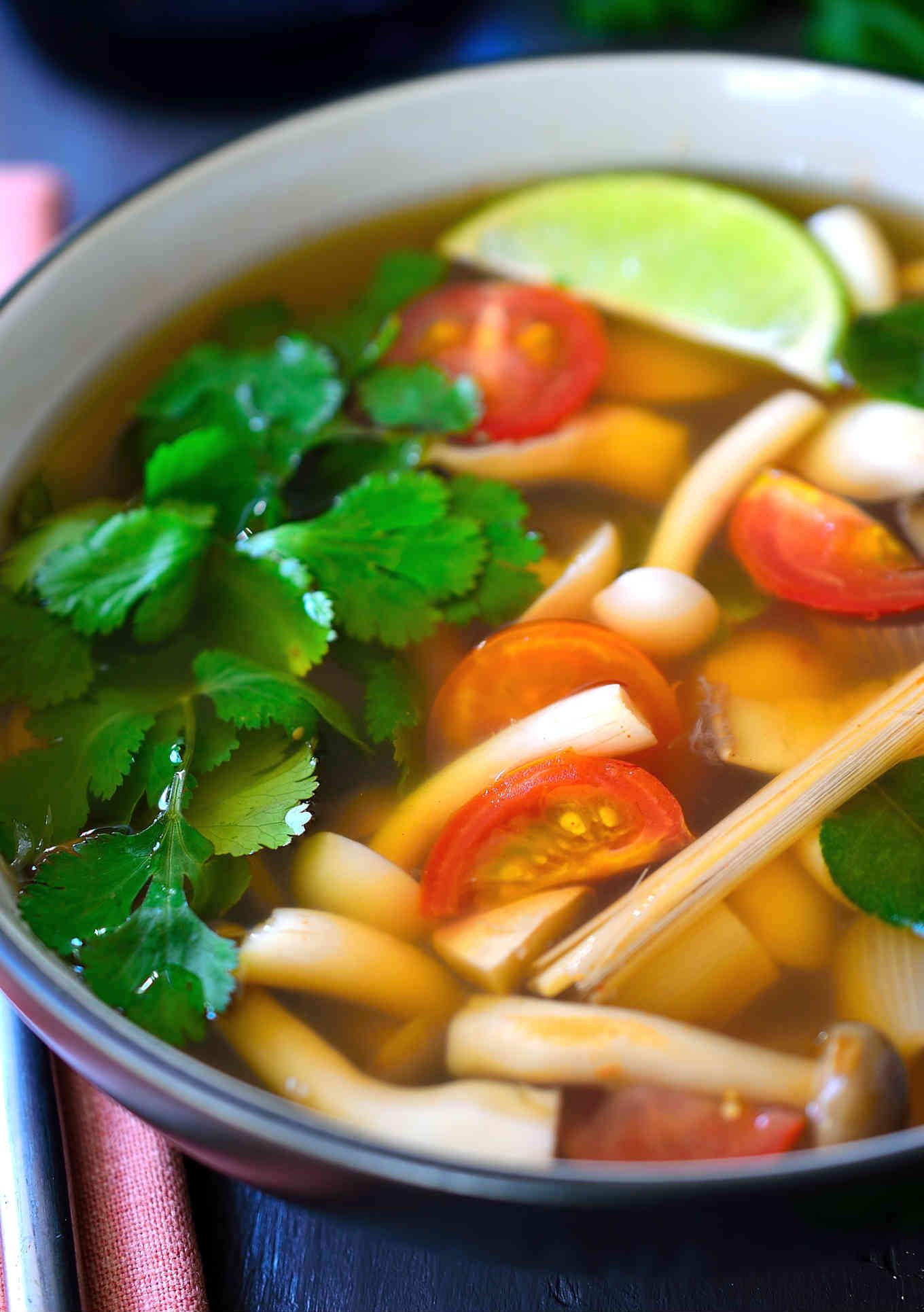 This vegetarian tom yum soup recipe is light, flavourful, spicy and hearty all at the same time. A mix of meaty Asian mushrooms are poached in a fragrant broth of lemongrass and lime leaves and soured with lime juice. A spoonful of chili paste is stirred in at the end for a bit of heat to warm you up and you’ve got a nourishing, steaming bowl of soup that’s great for chilly weather.