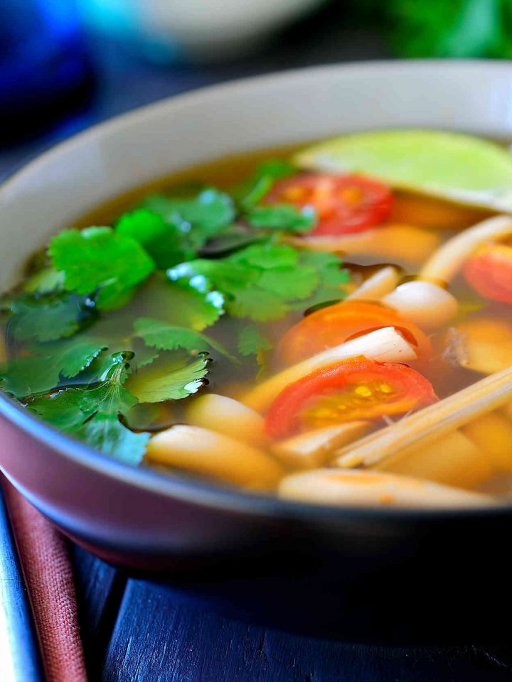 This vegetarian tom yum soup recipe is light, flavourful, spicy and hearty all at the same time. A mix of meaty Asian mushrooms are poached in a fragrant broth of lemongrass and lime leaves and soured with lime juice. A spoonful of chili paste is stirred in at the end for a bit of heat to warm you up and you’ve got a nourishing, steaming bowl of soup that’s great for chilly weather.