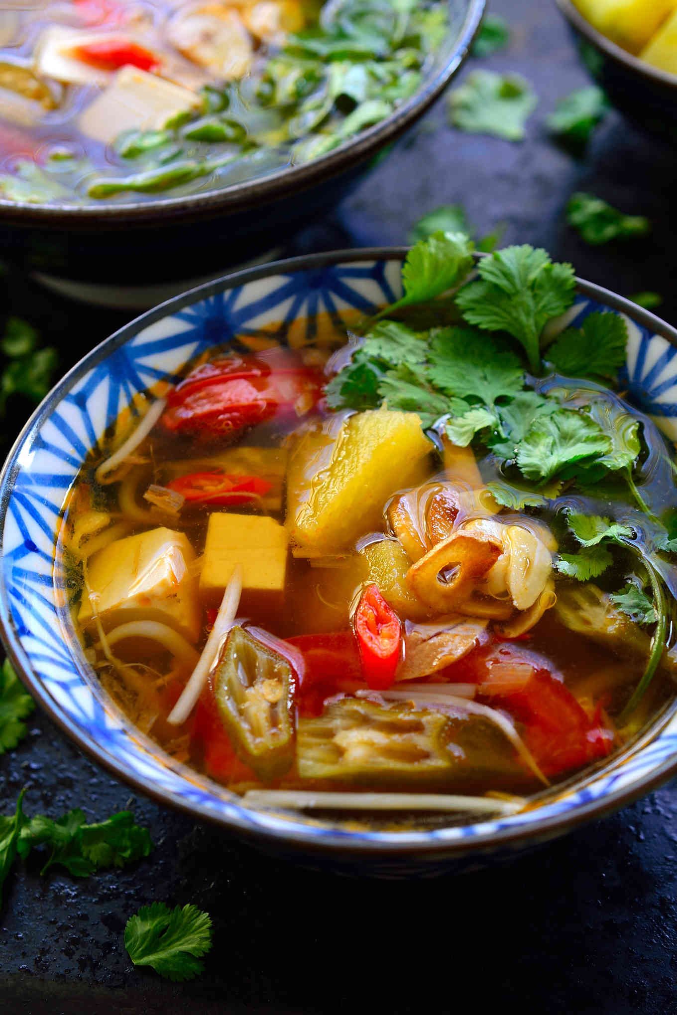 This Vietnamese sour soup recipe is ready in just 15 minutes and so full of complex flavours and textures that it just might be the most delicious bowl of soup youâve ever tasted. This is a vegetarian version of canh chua with tamarind, pineapple, okra and silken tofu. The combination seems weird but Iâm sure it will quickly become your new favourite soup!
