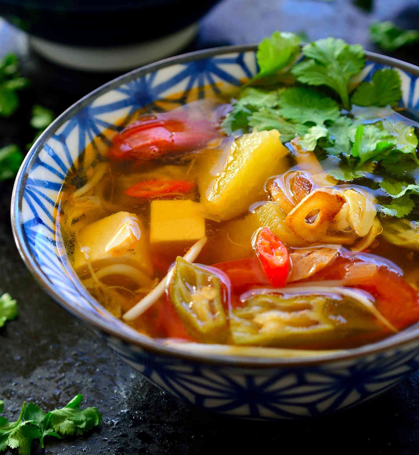 This Vietnamese sour soup recipe is ready in just 15 minutes and so full of complex flavours and textures that it just might be the most delicious bowl of soup you’ve ever tasted. This is a vegetarian version of canh chua with tamarind, pineapple, okra and silken tofu. The combination seems weird but I’m sure it will quickly become your new favourite soup!