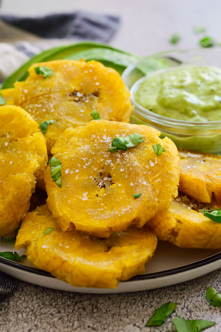 Patacones or tostones are two names for the same thing: fried green plantains. They are super easy to make and a great alternative to French fries. 
