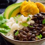 Cuban black beans and rice with tostones, avocado and cilantro.
