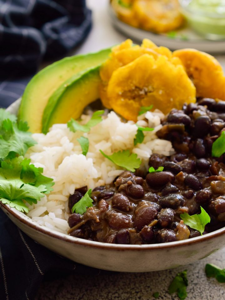 Cuban black beans and rice with tostones, avocado and cilantro.