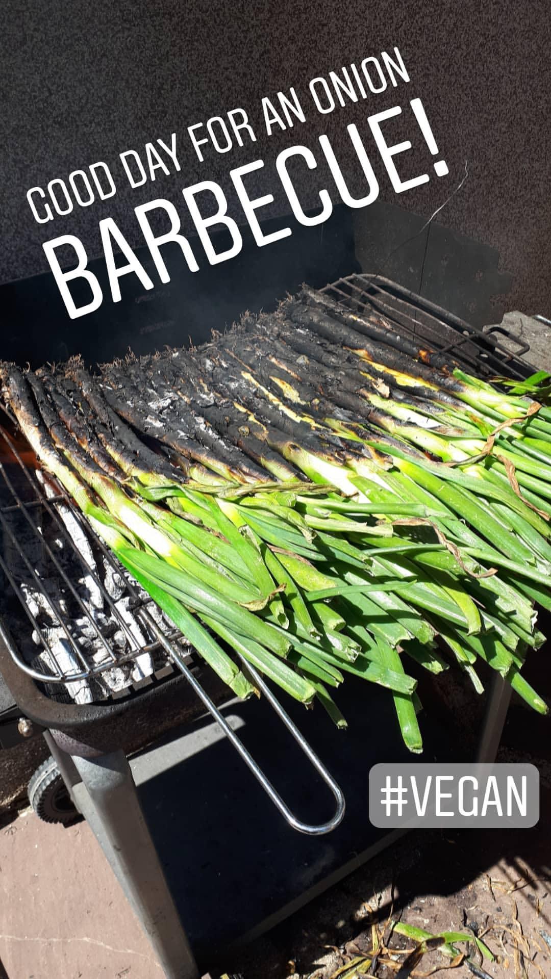 Calçots roasting on a barbecue.