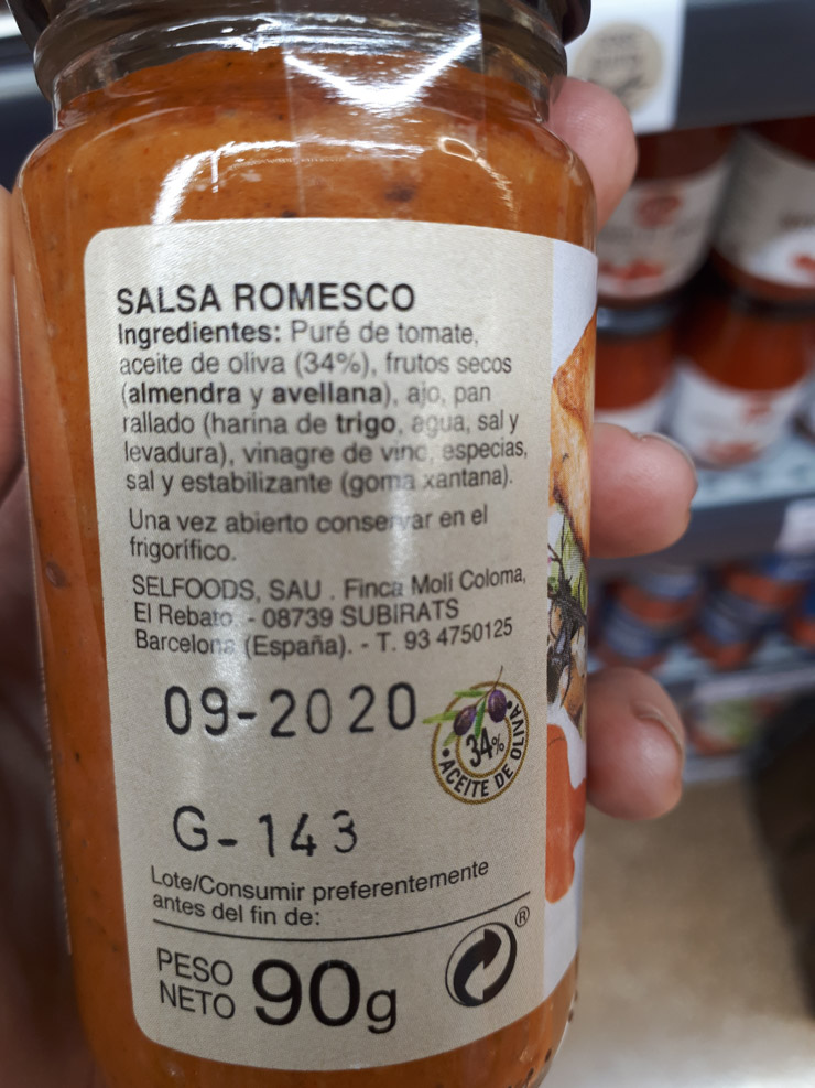 A jar of romesco sauce from the supermarket showing the first ingredient is tomatoes.